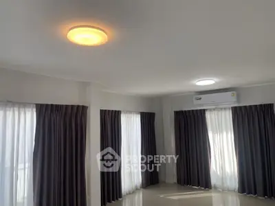 Spacious living room with modern lighting and large windows