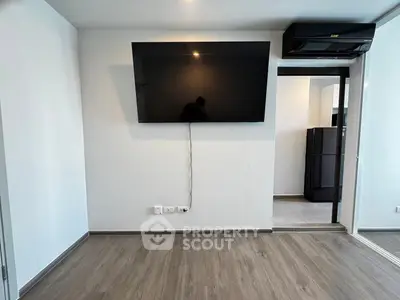 Modern living room with wall-mounted TV and sleek flooring
