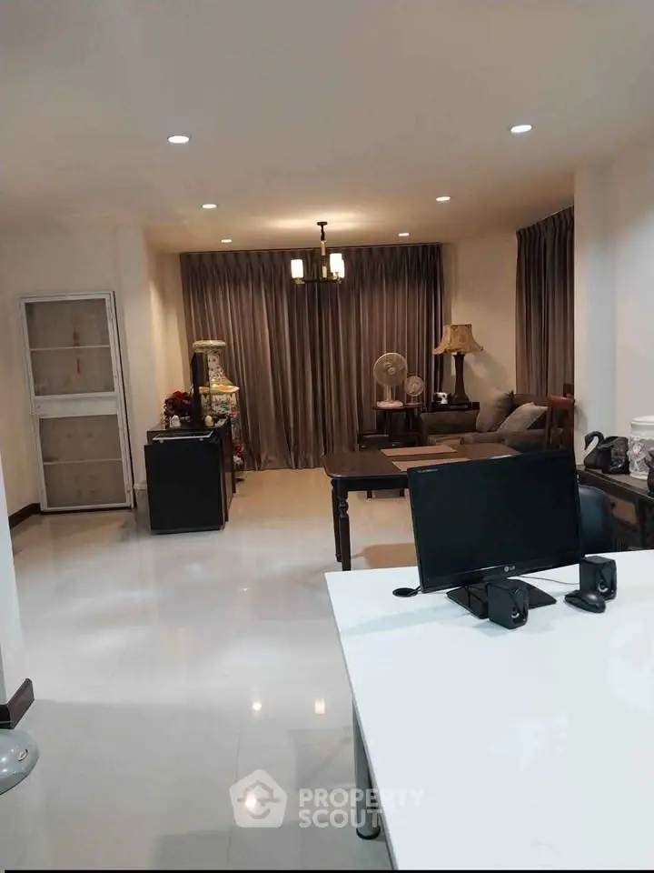 Spacious living room with modern decor and ample natural light, perfect for relaxation and entertainment.