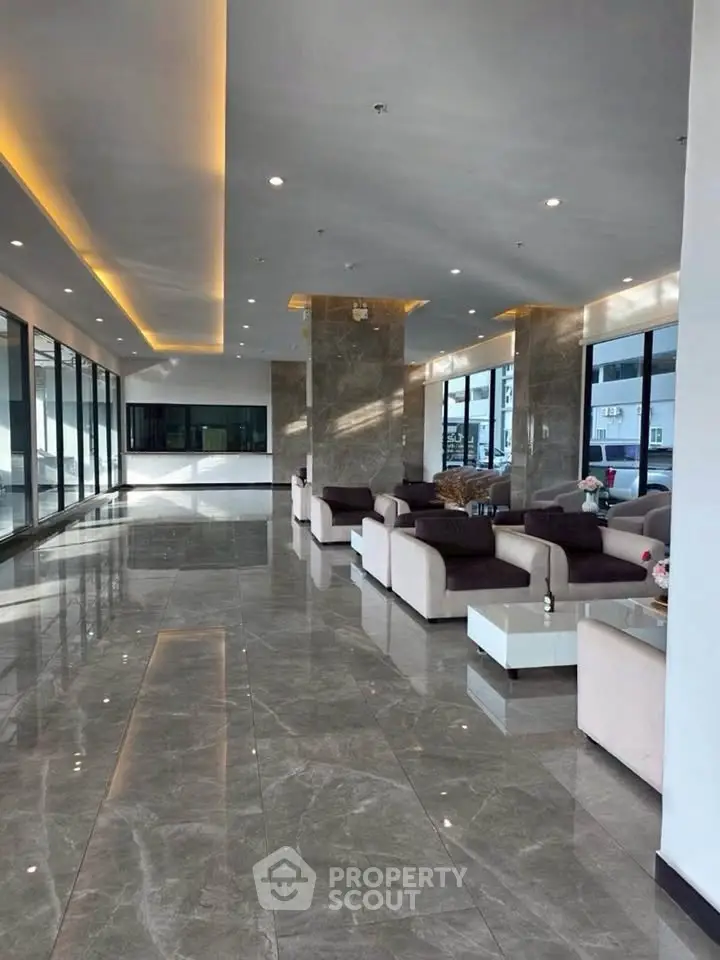 Luxurious modern living room with elegant marble flooring and plush seating in a spacious open layout.