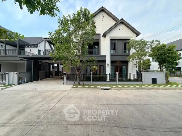 Elegant modern house with spacious driveway and lush greenery in a serene neighborhood.