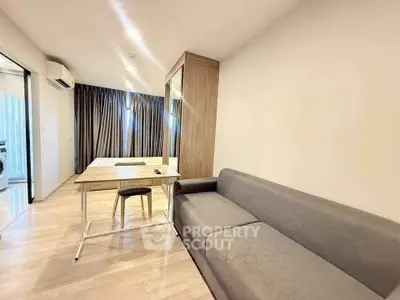 Modern living room with sleek furniture and wooden flooring in a stylish apartment.