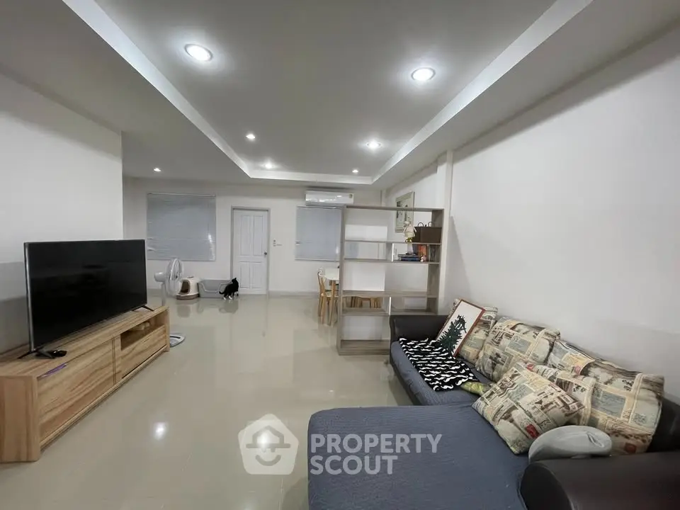 Spacious modern living room with stylish decor and ample natural light, perfect for relaxation and entertainment.