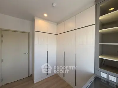 Modern bedroom with sleek built-in wardrobes and wooden flooring