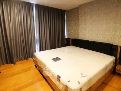 Spacious bedroom with elegant wallpaper and large windows