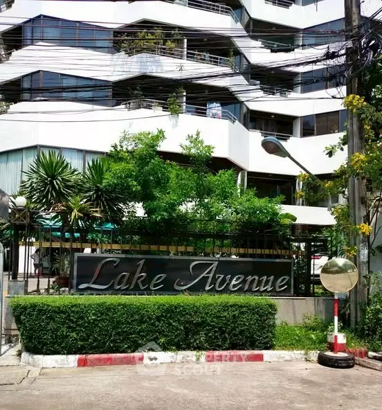 Modern building exterior with lush greenery at Lake Avenue