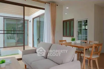 Spacious living room with modern furniture and dining area in a bright, open-concept home.