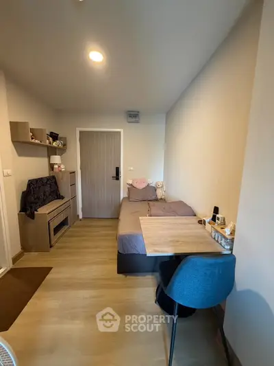 Cozy small living room with modern decor and wooden flooring, perfect for compact urban living.