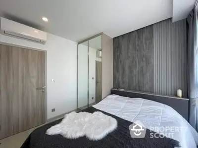 Modern bedroom with stylish decor and mirrored wardrobe in a contemporary apartment.