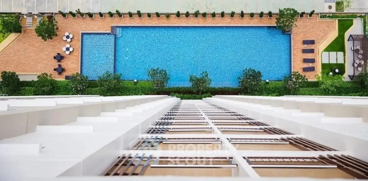Stunning aerial view of a luxurious swimming pool in a modern residential complex.