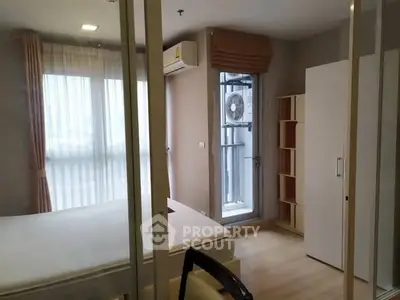 Modern bedroom with large window and air conditioning unit