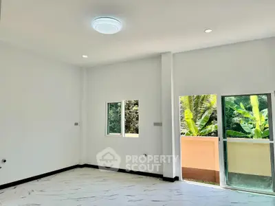 Spacious modern room with large windows and balcony access, perfect for natural light lovers.