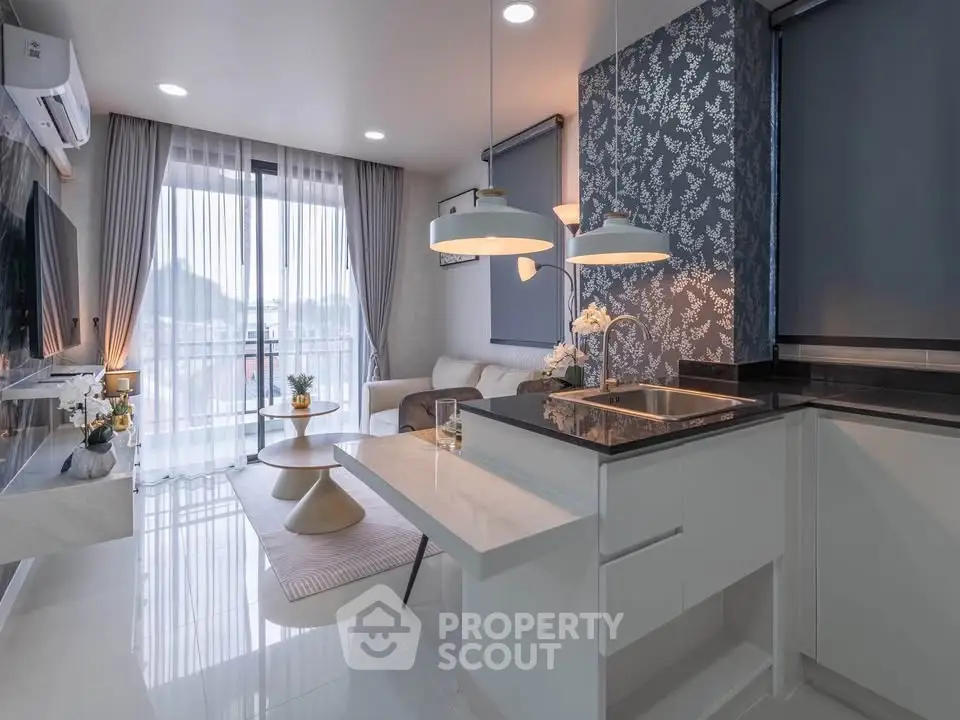Modern open-layout living room with stylish kitchen and elegant decor
