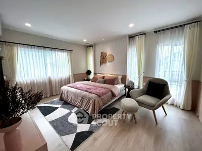 Spacious modern bedroom with elegant decor and natural light