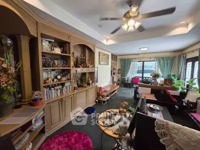 Spacious living room with built-in shelves and cozy seating area