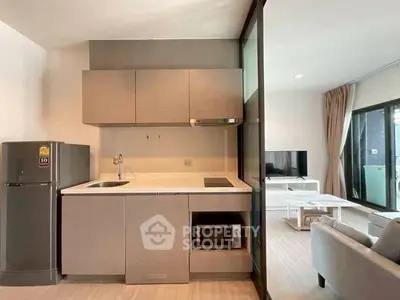 Modern open-layout kitchen with sleek cabinetry and integrated appliances in a stylish apartment.
