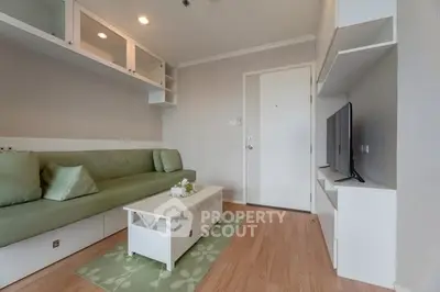 Modern living room with sleek furniture and wall-mounted TV