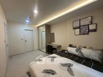 Modern bedroom with stylish decor and mirrored wardrobe in a cozy apartment.