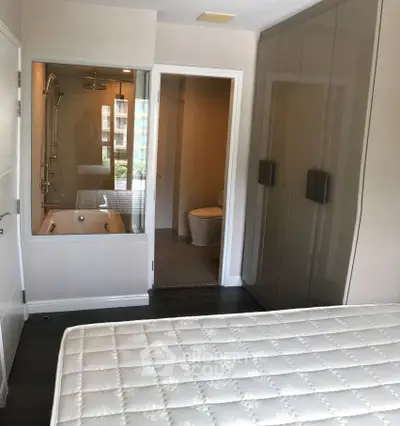 Modern bedroom with ensuite bathroom and sleek wardrobe design