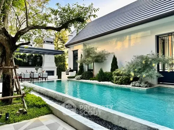 Luxurious modern home with stunning pool and lush garden, perfect for relaxation and entertaining.