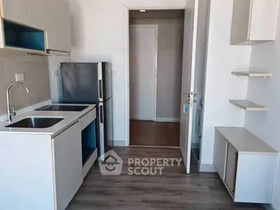 Modern kitchen with sleek cabinetry and stainless steel appliances in a compact layout.