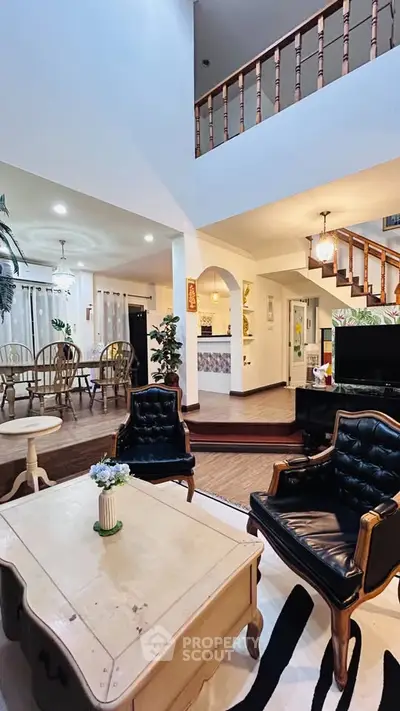 Spacious living room with elegant furniture and open dining area in a stylish home.