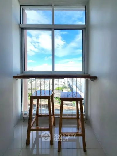Bright balcony with stools and stunning view, perfect for relaxation and enjoying the outdoors.