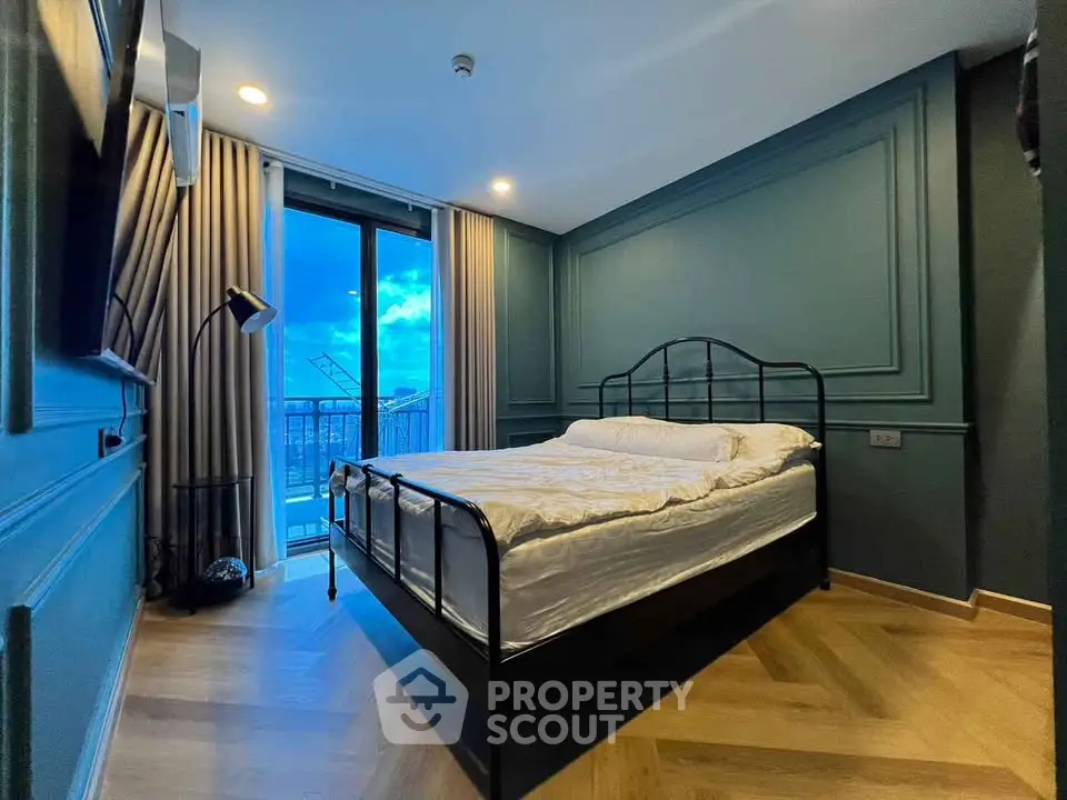 Modern bedroom with elegant design and balcony view, featuring stylish decor and natural light.