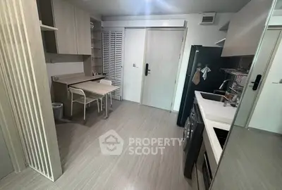 Modern compact kitchen with sleek appliances and dining area