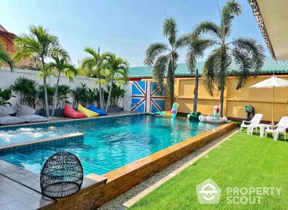 Luxurious backyard with sparkling pool and lush greenery, perfect for relaxation and entertainment.