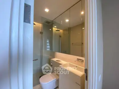 Modern bathroom with sleek fixtures and glass shower enclosure