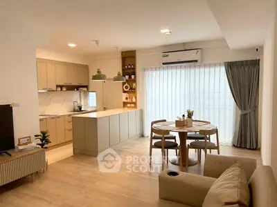 Modern open-plan living room and kitchen with stylish decor and natural light