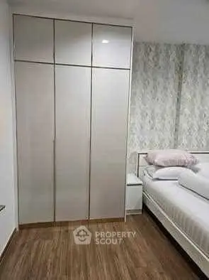 Modern bedroom with sleek wardrobe and stylish decor