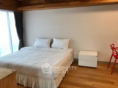 Spacious bedroom with modern decor and natural light