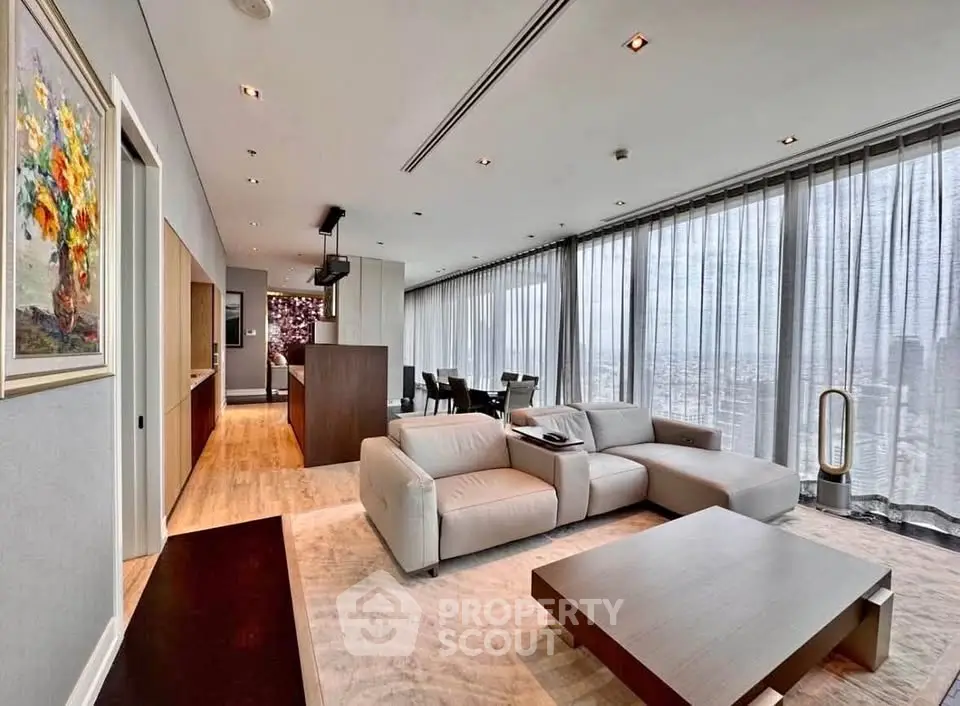 Luxurious modern living room with panoramic city views and elegant furnishings.