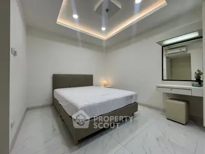 Modern minimalist bedroom with elegant lighting and sleek furnishings
