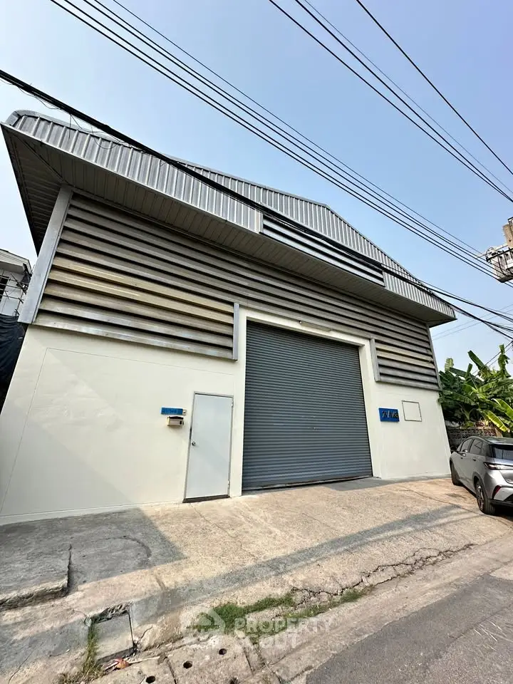 Industrial warehouse with large roller door and modern facade