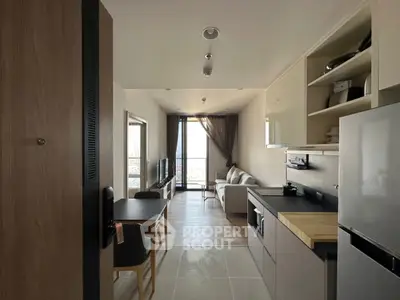 Modern open-plan living room and kitchen with sleek design and natural light.