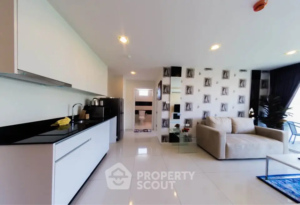 Modern open-plan living room with sleek kitchen and stylish decor