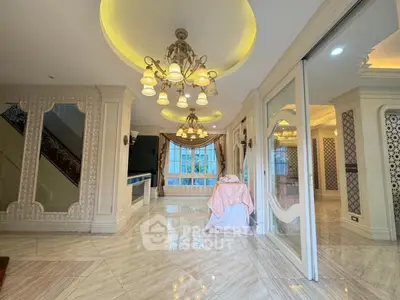 Luxurious living room with elegant chandelier and large windows