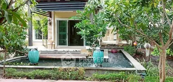 Charming garden view with serene water feature and lush greenery