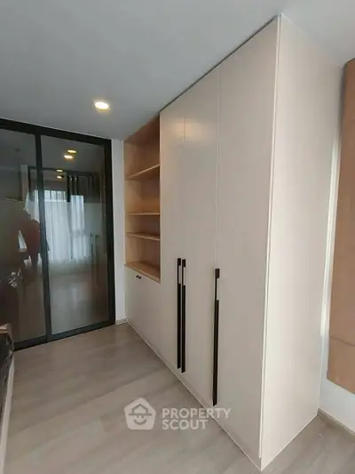 Modern bedroom with sleek built-in wardrobe and sliding glass door