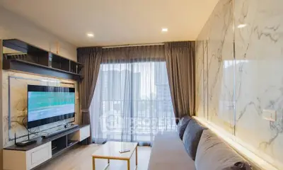 Luxurious living room with marble walls and city view, featuring modern entertainment setup and elegant decor.