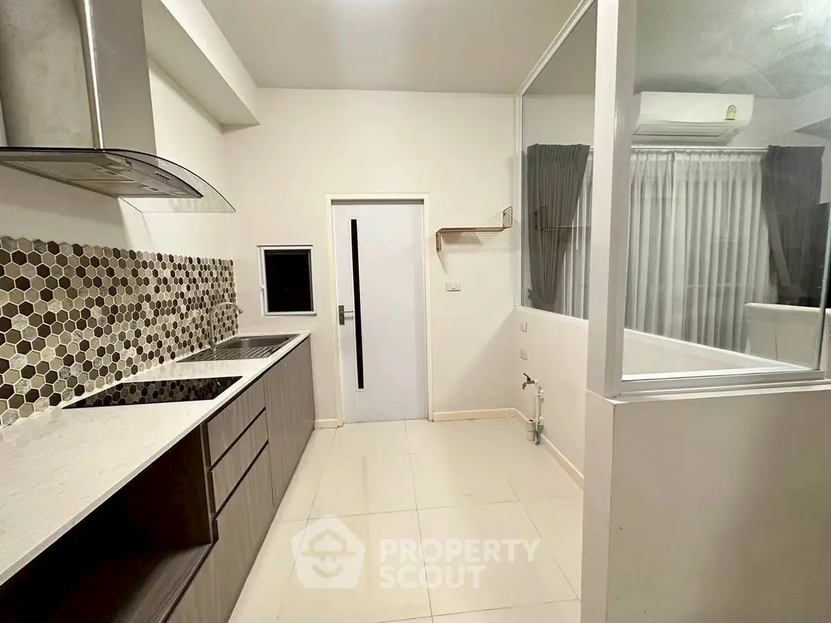 Modern kitchen with sleek cabinetry and stylish backsplash