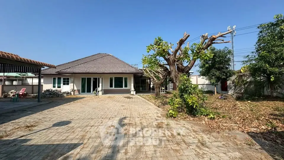 Charming single-story home with spacious driveway and lush garden, perfect for family living.