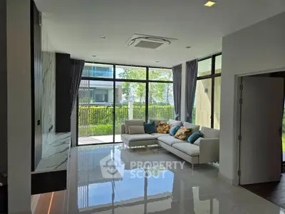 Spacious modern living room with large windows and garden view