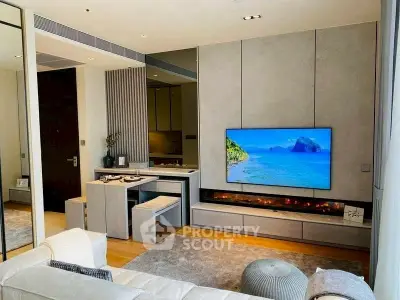 Modern living room with sleek design and large TV, featuring cozy seating and stylish decor.