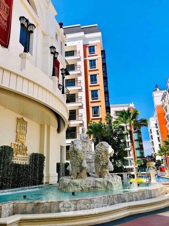 Luxurious residential building with elegant fountain and classic architecture.