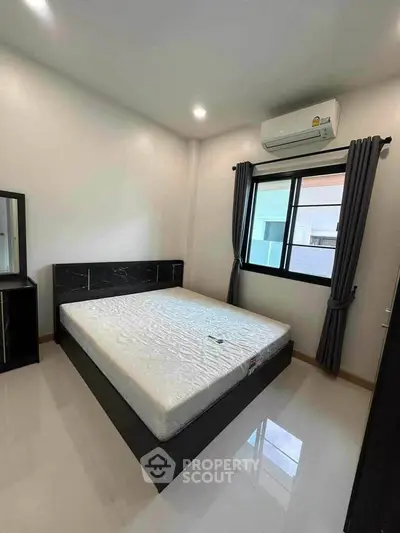 Modern bedroom with large window and air conditioning unit