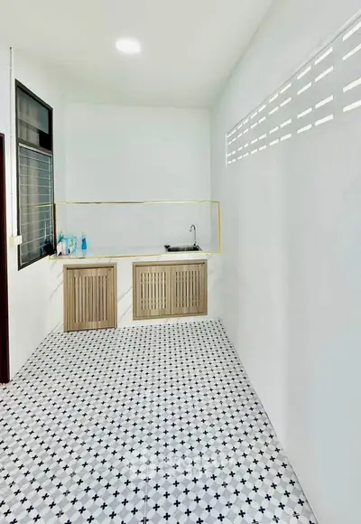 Modern minimalist kitchen with sleek cabinetry and stylish tile flooring